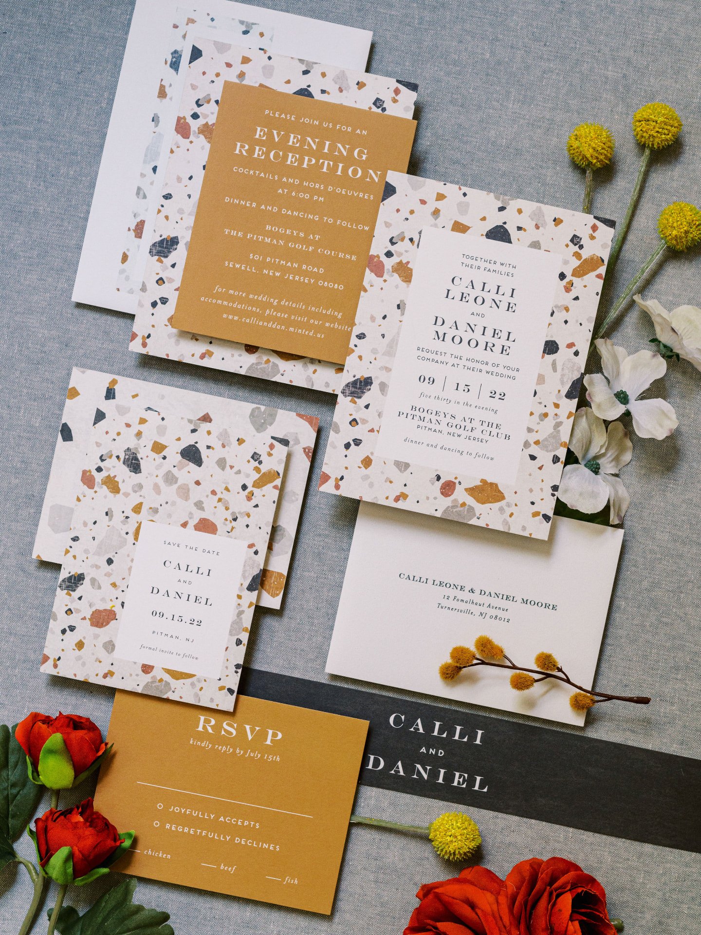 A terrazzo invitation suite laid out with save the date, invitation and RSVP cards