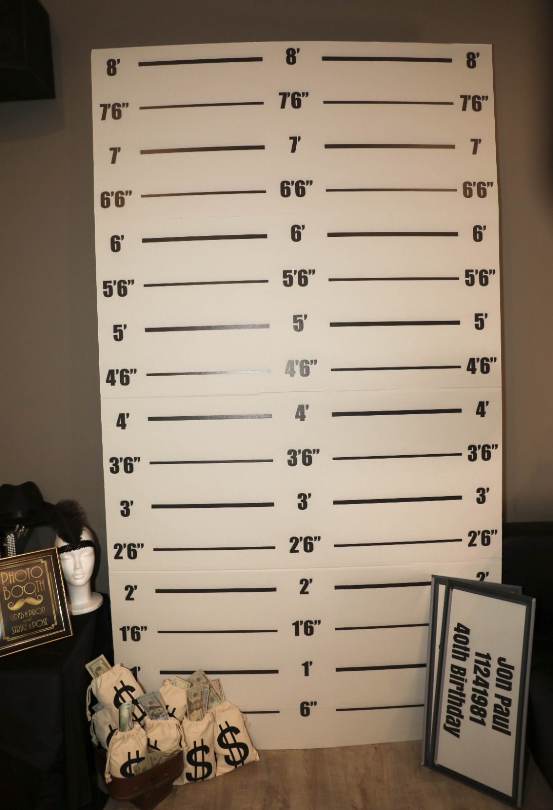 A mugshot height chart photo backdrop for a themed party
