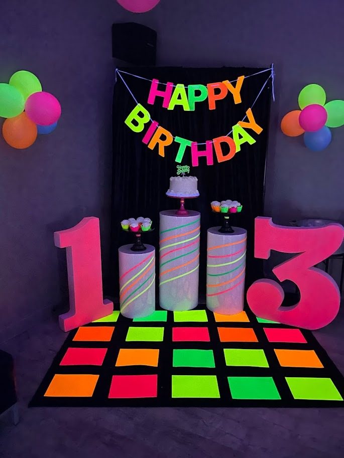 A neon glow birthday setup with a lit dance floor