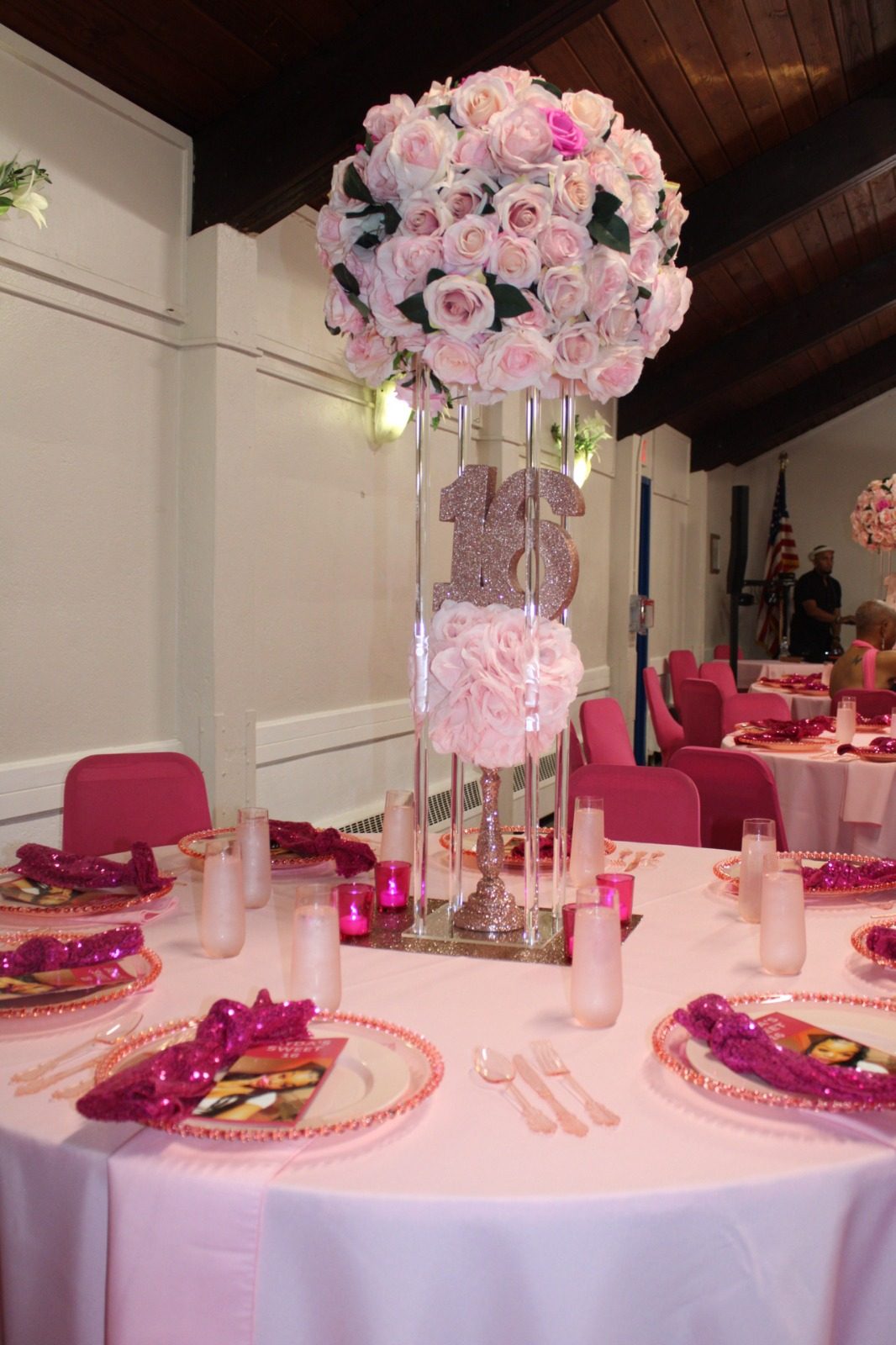 A blush tea party table with tall floral centerpieces