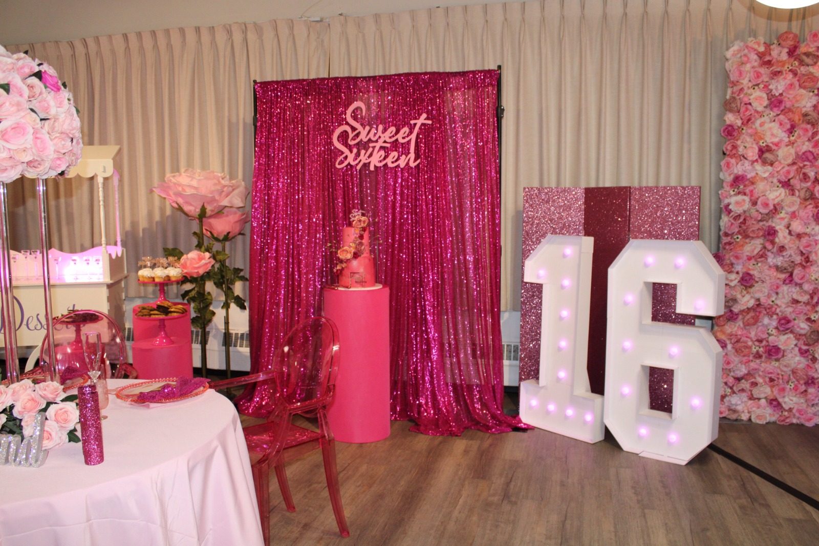 A hot pink sweet sixteen backdrop with marquee numbers