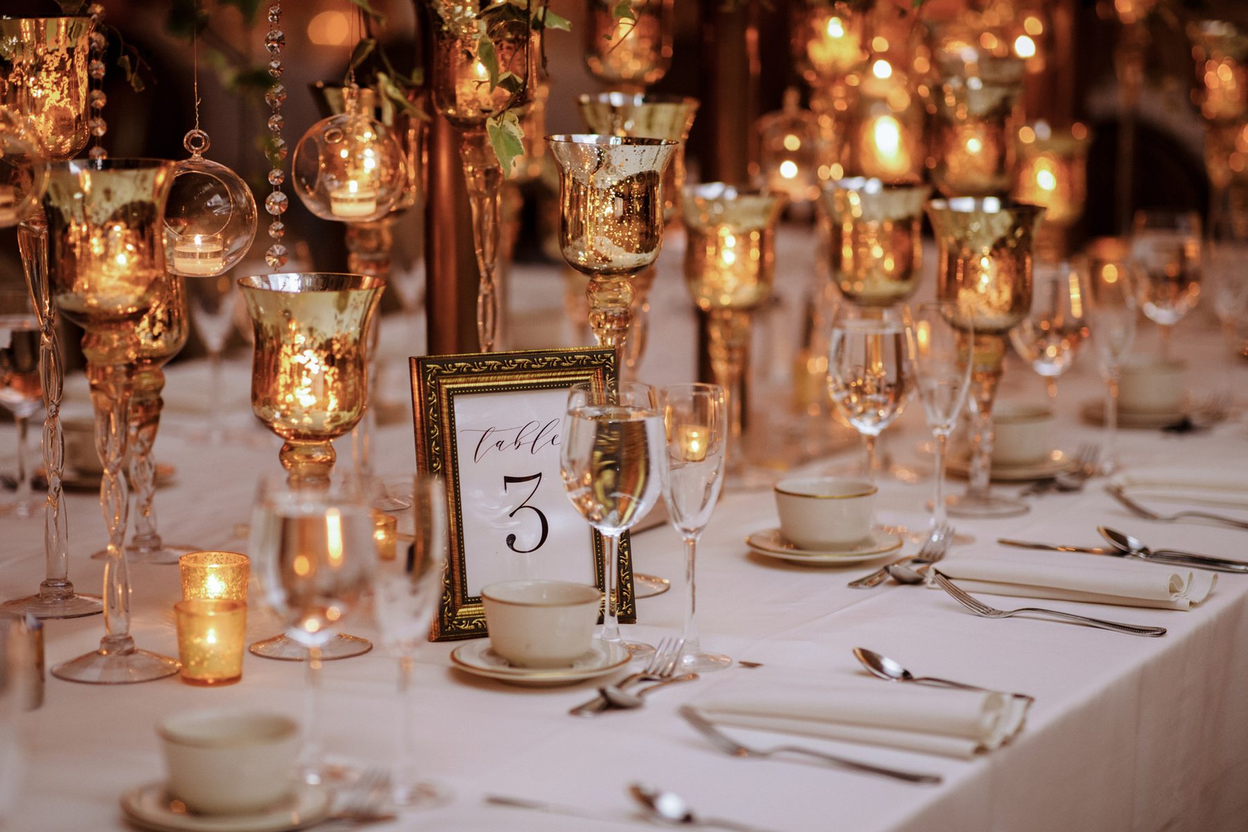 Candlelight reflecting across gold table details