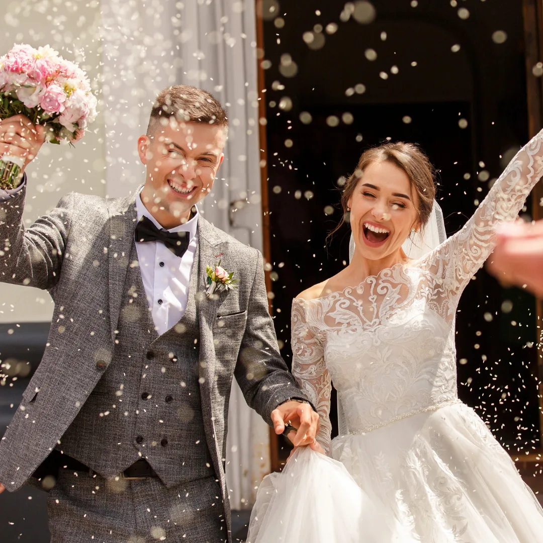 wedding couple recessional with rice being thrown in the air