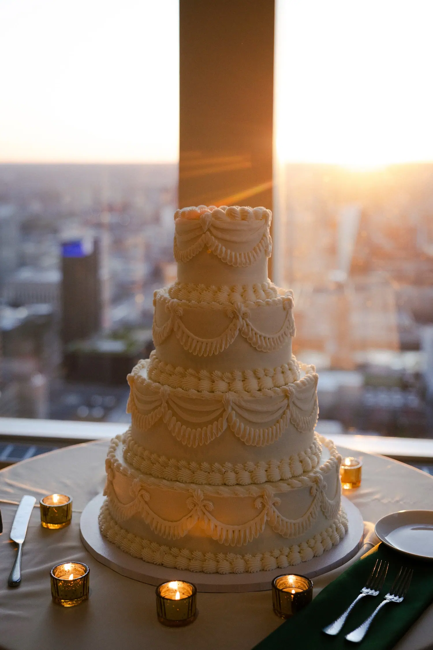 A tiered cake against the skyline at sunset
